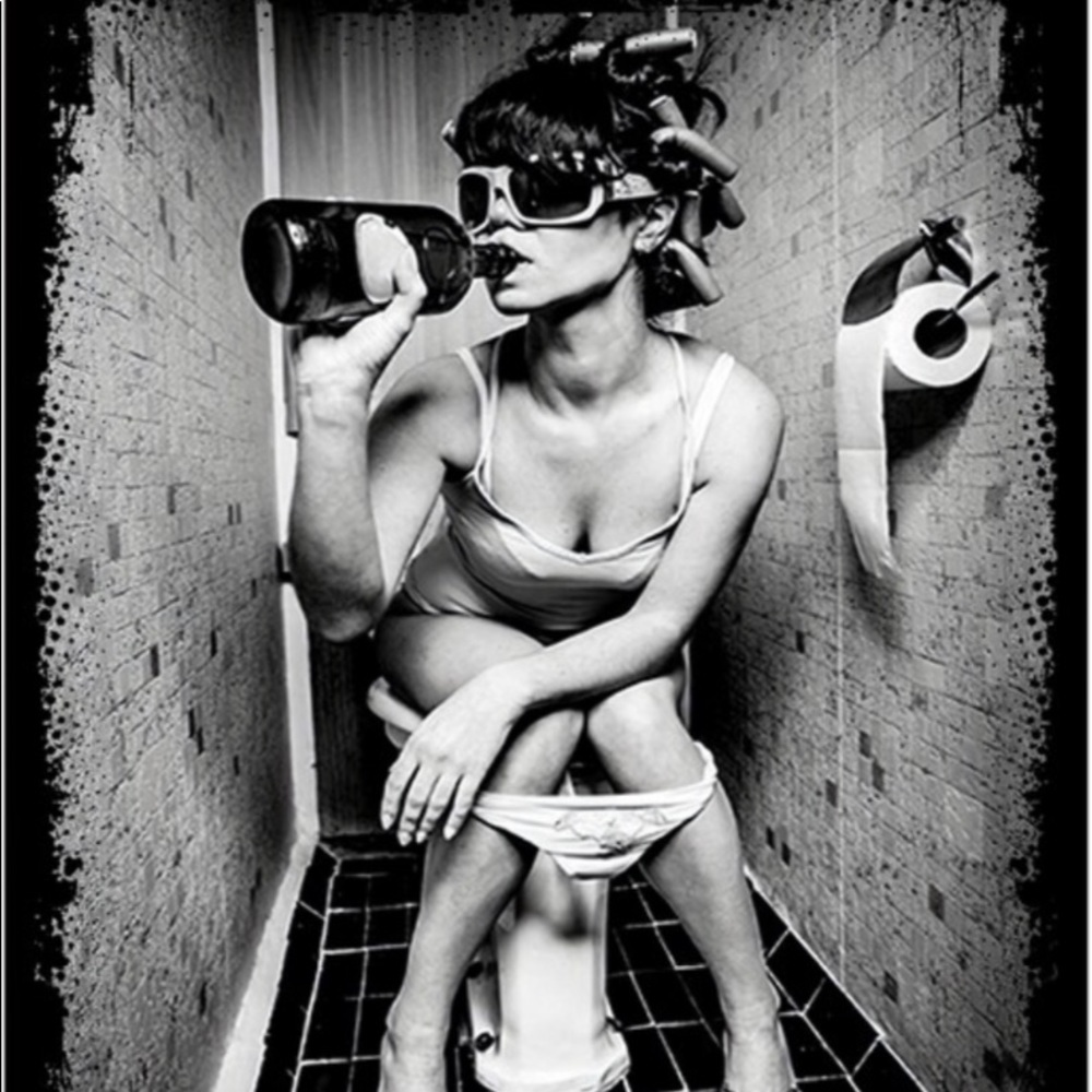 Art: bathroom : woman drinking on a toilet
